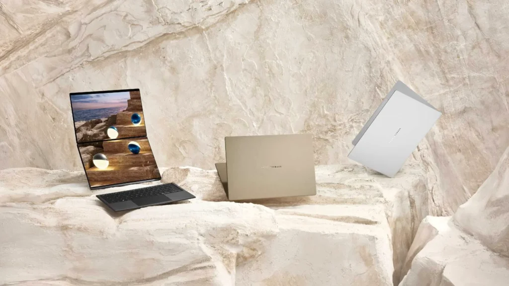 Three ASUS laptops with open screens, showcasing vibrant OLED displays.